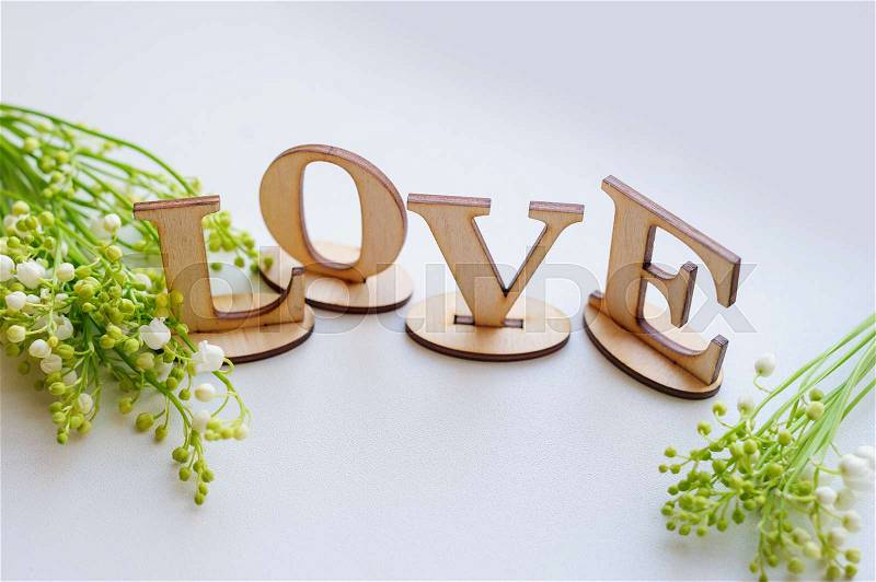 Wooden letters love and Lily on the table, stock photo