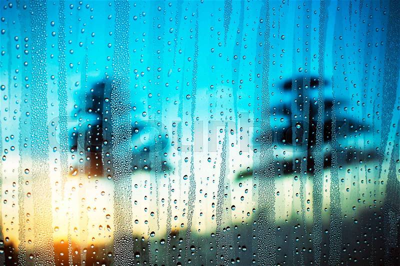Water droplets on glass with morning light in winter, stock photo