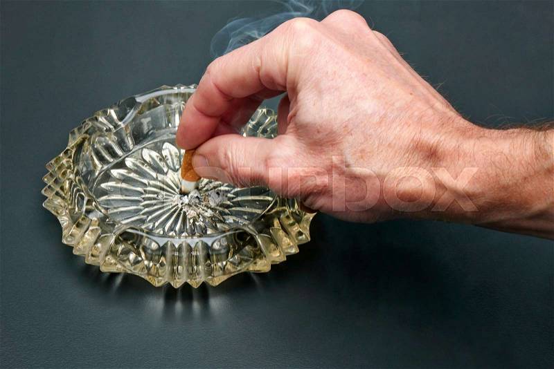 Man Give up smoking cigarette and crystal ashtray, stock photo