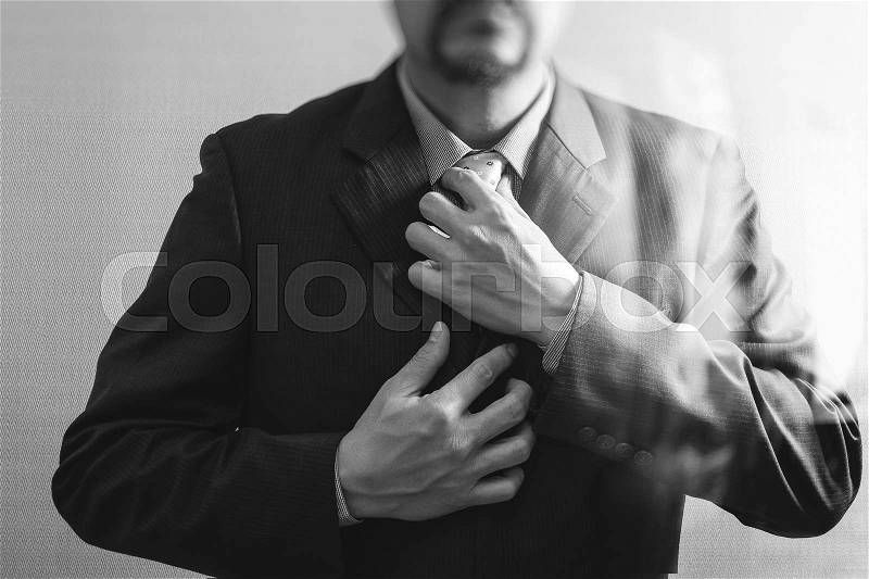 Businessman adjusting tie,Front view, no head. Concept of working in an office.black white, stock photo