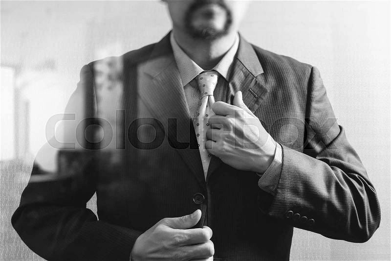 Businessman adjusting tie,Front view, no head. Concept of working in an office.black white, stock photo