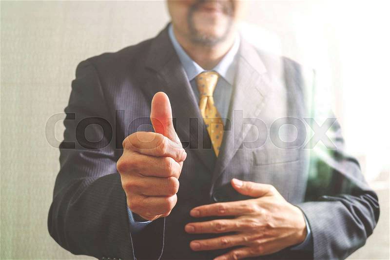 Businessman with his thumb up Front view, no head. Concept of working in an office.filter effect, stock photo