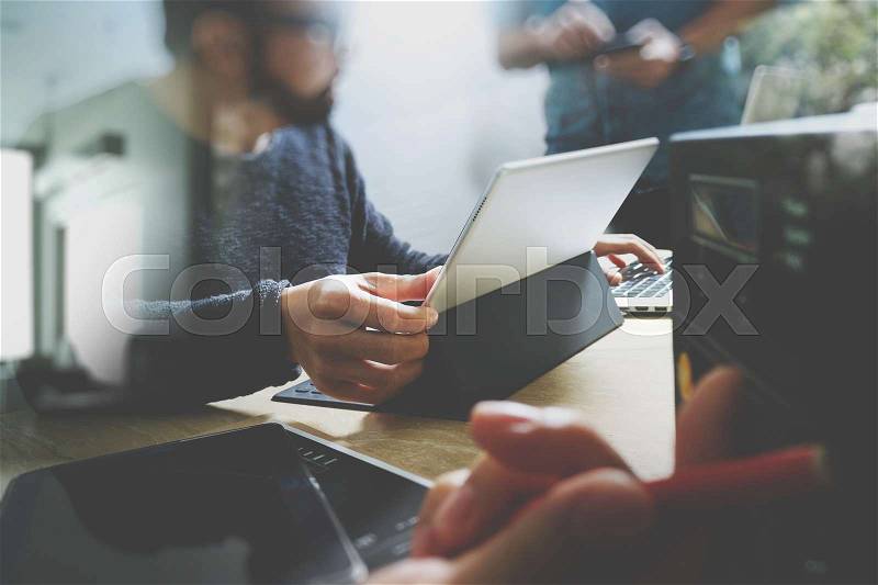 StartUp Programming Team. Website designer working digital tablet dock keyboard and computer laptop with smart phone and compact server on mable desk,light effect , stock photo