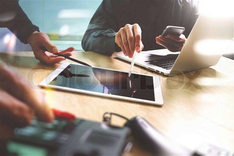 Business team meeting present. Photo professional investor working with new startup project. Finance managers meeting.Digital tablet laptop computer design smart phone using.Sun flare effect, stock photo
