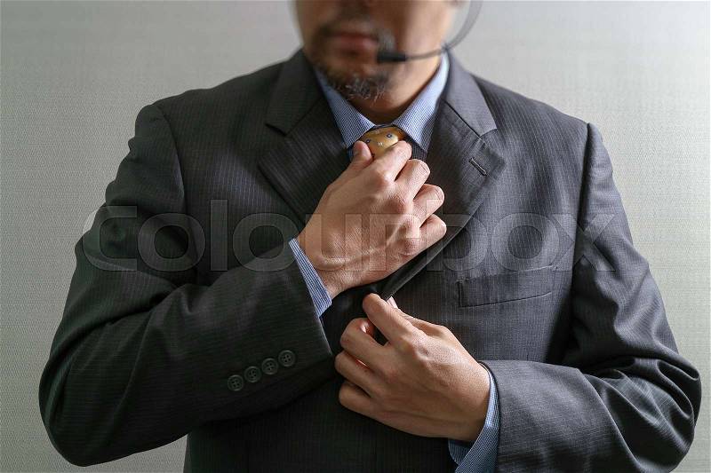 VOIP Businessman adjusting tie,Front view, no head. Concept of working in an office, stock photo