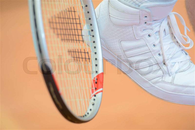 Tennis racket and shoe, stock photo