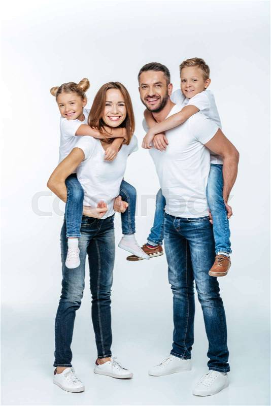 Smiling parents piggybacking happy children isolated on white, stock photo