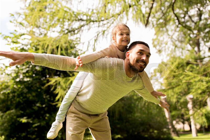 Family, parenthood, fatherhood and people concept - happy man and little girl in having fun in summer park, stock photo