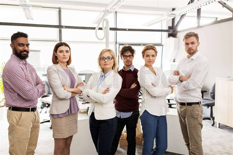 Corporate, teamwork and peope concept - happy business team in office, stock photo