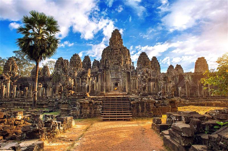 Ancient stone faces at sunset of Bayon temple, Angkor Wat, Siam Reap, Cambodia, stock photo