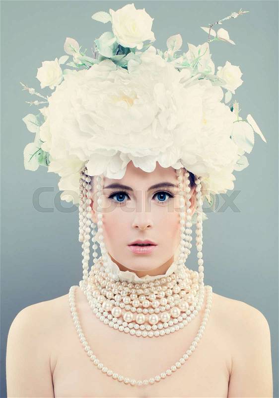 Elegant Woman with White Flowers. Young Face, Makeup, Roses and Jewelry, stock photo