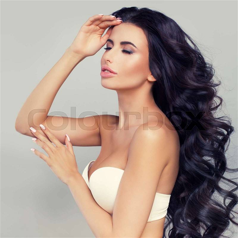 Relaxing Woman with Long Dark Hair and Natural Makeup. Cute Fashion Model, stock photo