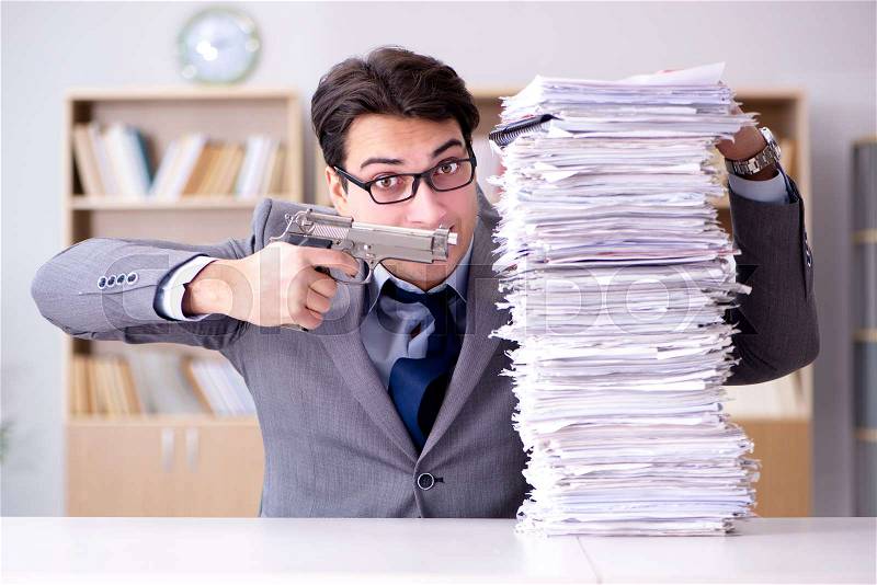 Businessman struggling to meet challenging deadlines, stock photo