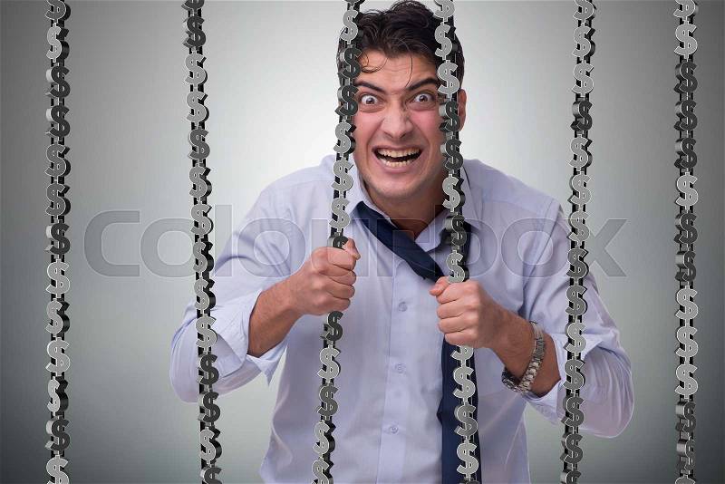 Man trapped in prison with dollars, stock photo