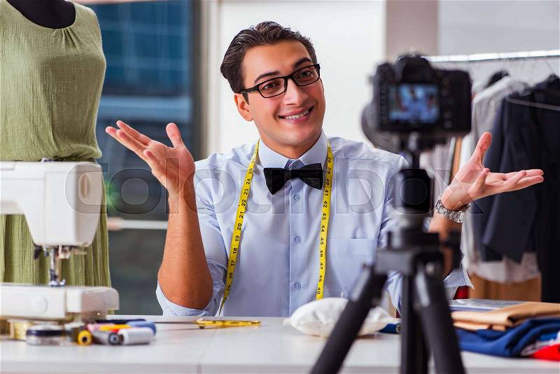 Young man working as fashion video blogger, stock photo