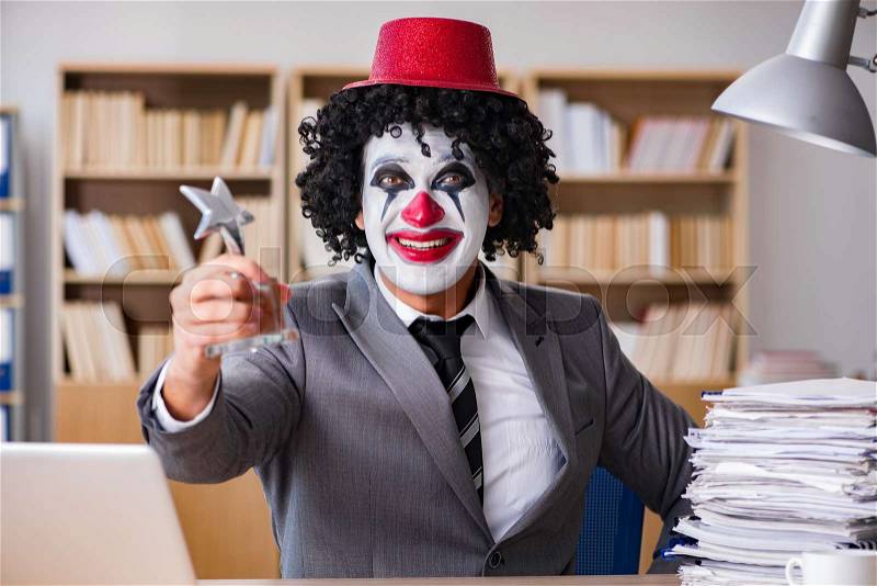 Clown businessman working in the office, stock photo