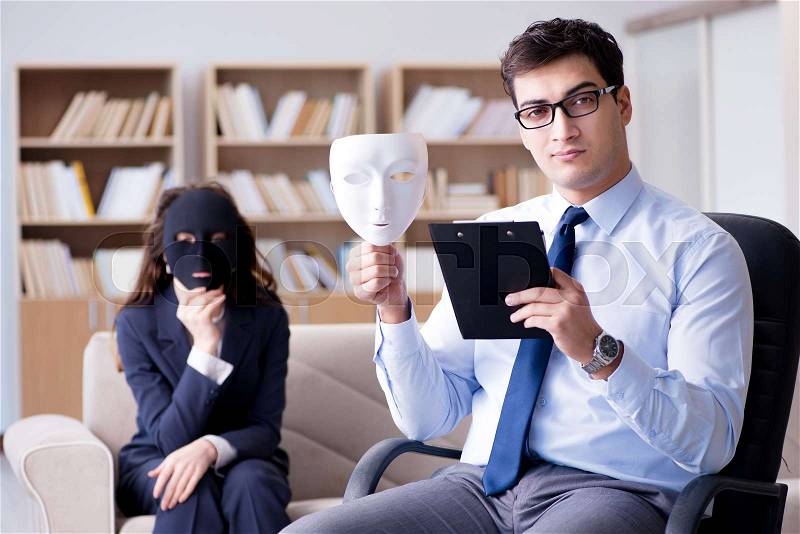 Woman with mask during psychologist visit, stock photo