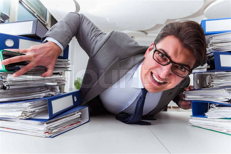 Businessman under stress due to excessive work, stock photo