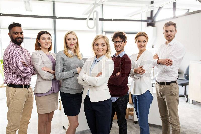 Corporate, teamwork and people concept - happy business team in office, stock photo