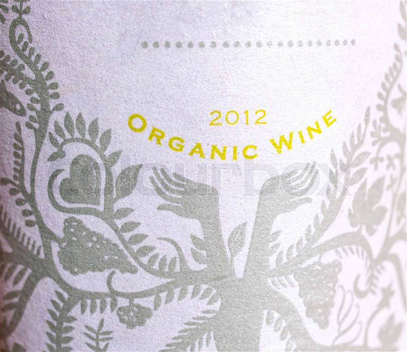 Organic wine label on wine glass bottle , stock photo