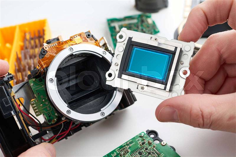 Image sensor digital SLR camera in the hands of the service engineer, stock photo