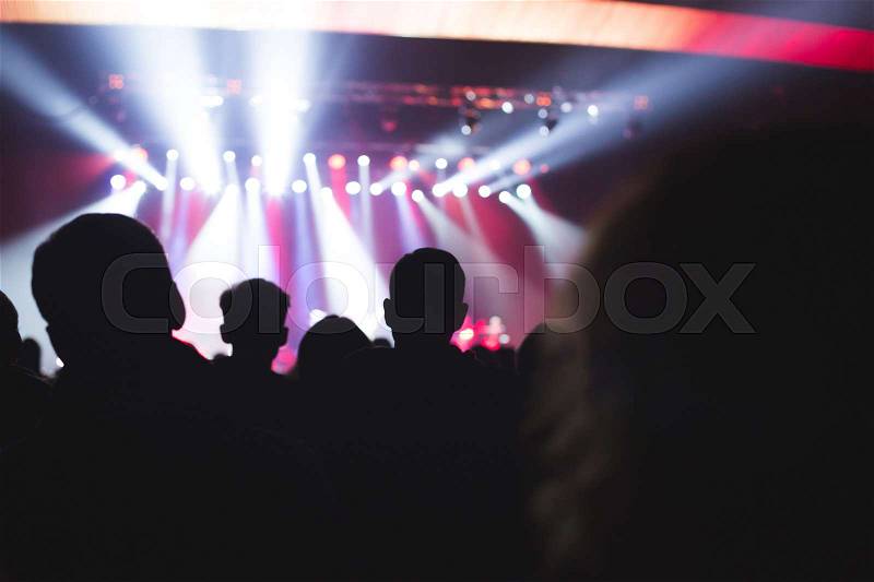 The audience watching the concert on stage, stock photo