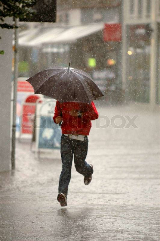 Man running in the rain, stock photo