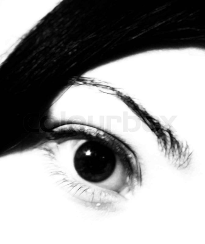 A soft, black and white eye of a pretty girl - looking right at you, stock photo