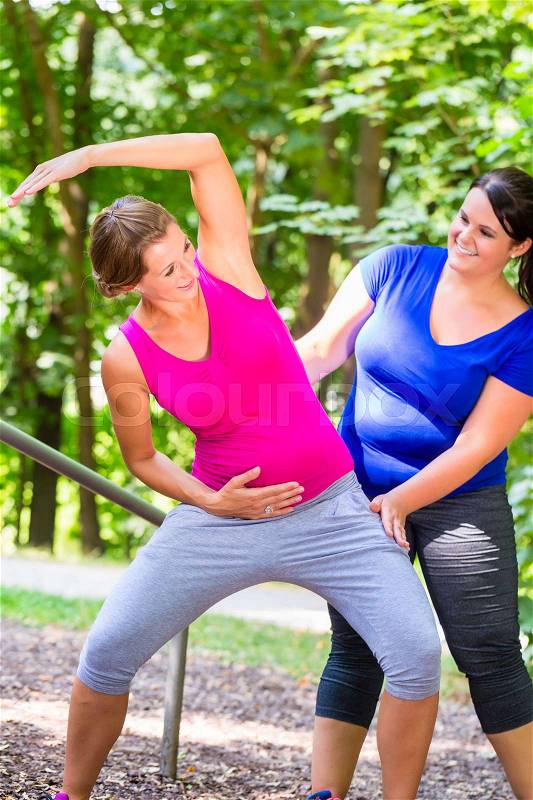 Women doing pregnancy fitness exercises together, stock photo