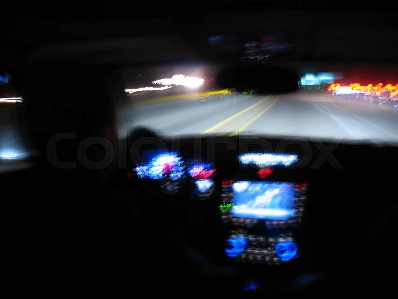 Driving at night in a modern luxury vehicle interior, stock photo