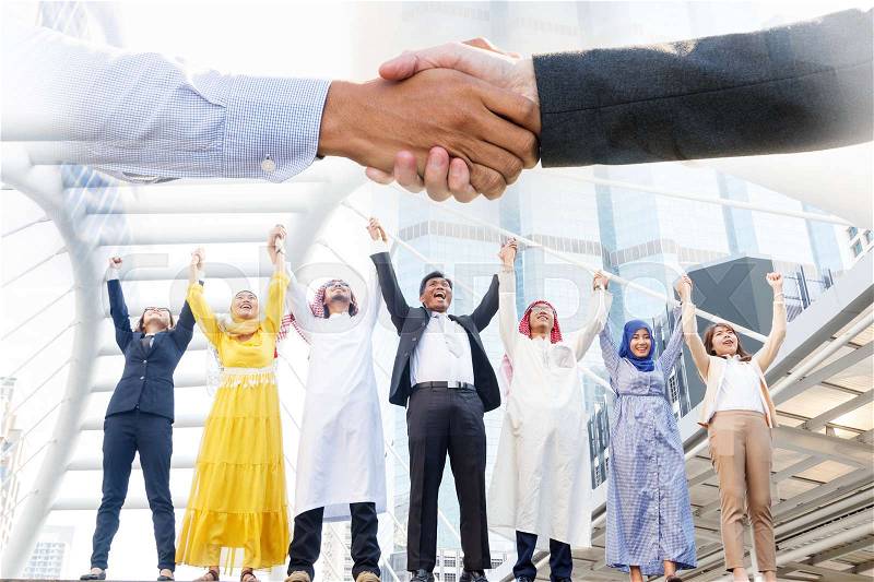 Arab and business team standing by raising both hands up , success in their business, stock photo