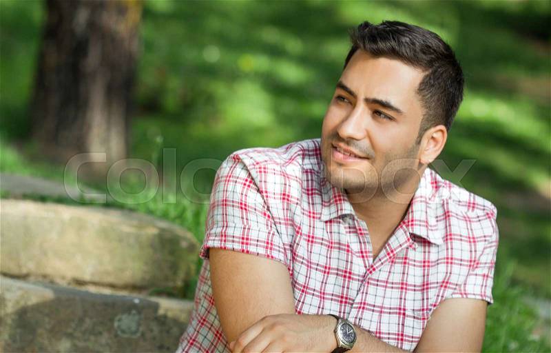 Portrait of a smile young man. Profile - sideways of happy gorgeous guy, stock photo