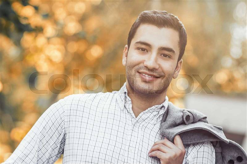 Portrait of gorgeous young smile man. Outdoor - outside. Happy turkish guy, stock photo