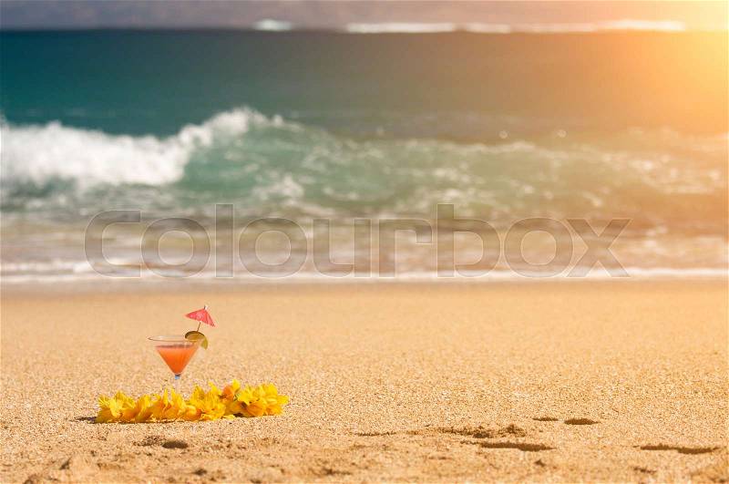 Tropical Drink and Lei on a Sandy Beach Shoreline, stock photo