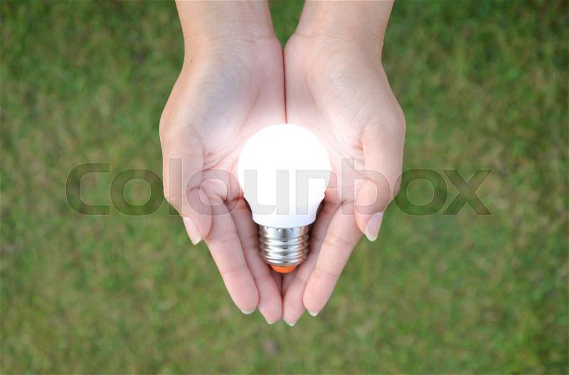 LED bulb with lighting in human - saving technology, stock photo