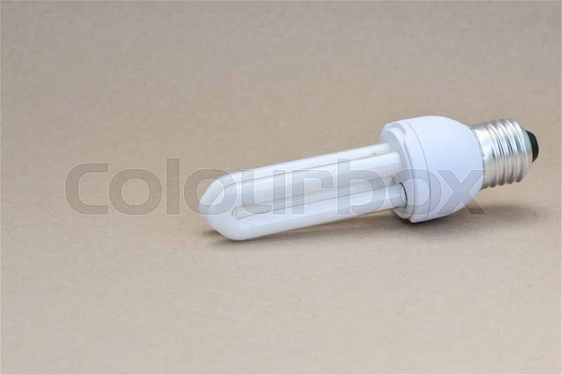 Compact Fluorescent Lamp on the brown background, stock photo