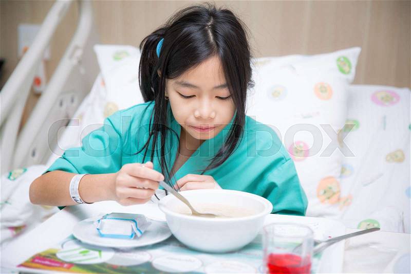 Woman patient in hospital bed from cold and eating food for patient person, stock photo