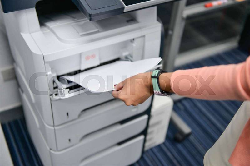 Woman is using the printer to scanning the document, stock photo