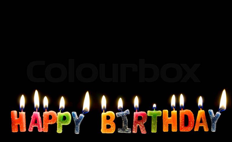 Colorful of happy birthday candle with flame lighting on the black screen, stock photo