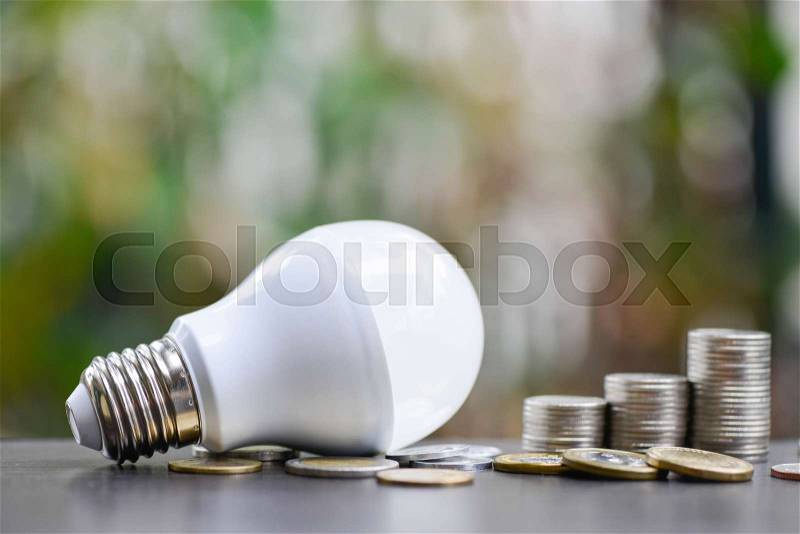 LED Bulb and Coin stack - Saving concept, stock photo