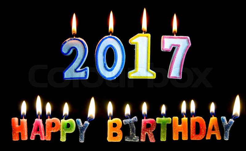 Colourful of 2017 happy birthday candle with flame lighting on the black screen, stock photo