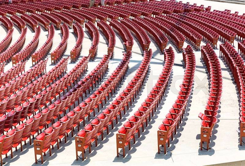 Empty open air theater red color circular placed seats, stock photo