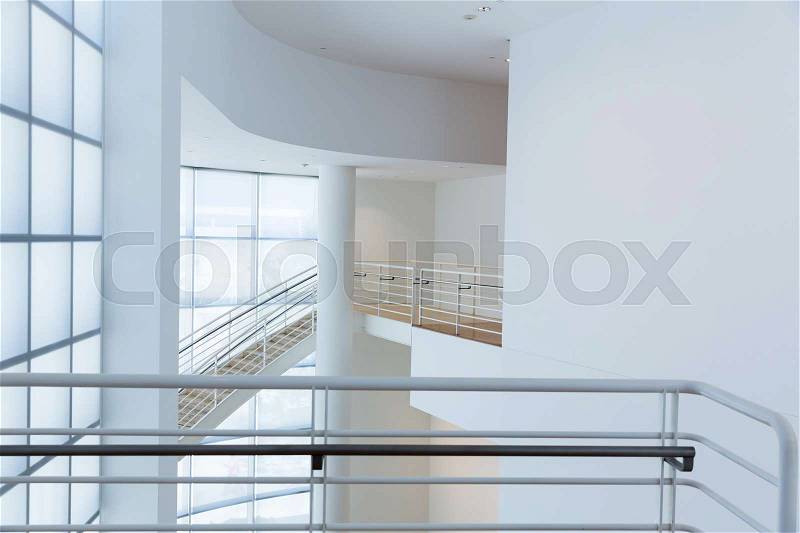 Access stair with metal handrails against glassed wall. High tech building, stock photo
