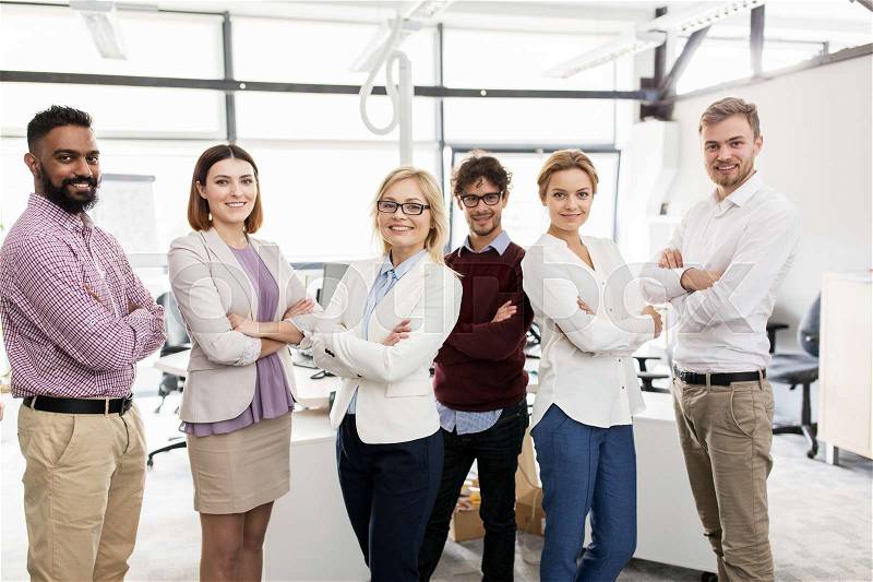 Corporate, teamwork and peope concept - happy business team in office, stock photo