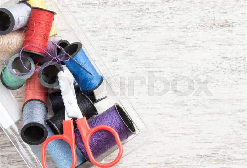 Sewing accessories,spools of thread with scissors on wood background,top view, stock photo