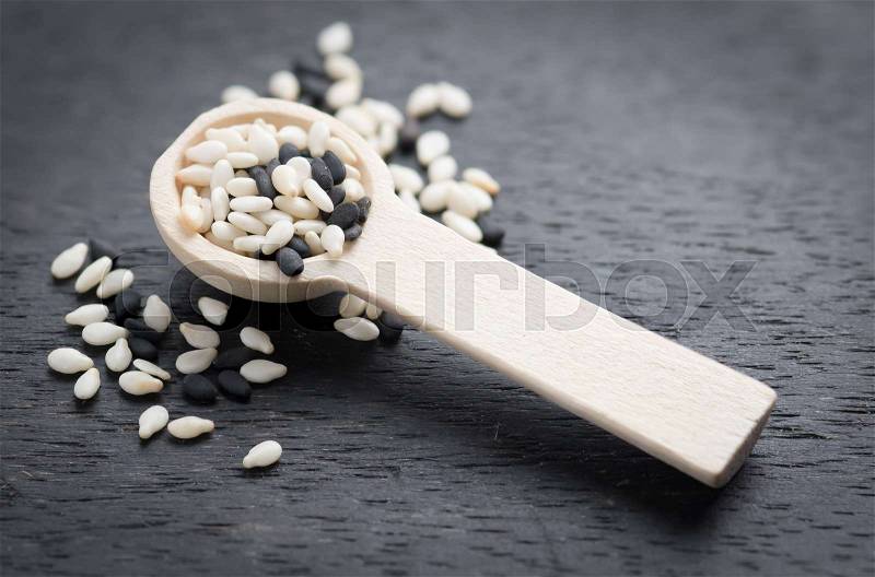 White sesame and black sesame seed on dark wooden , stock photo