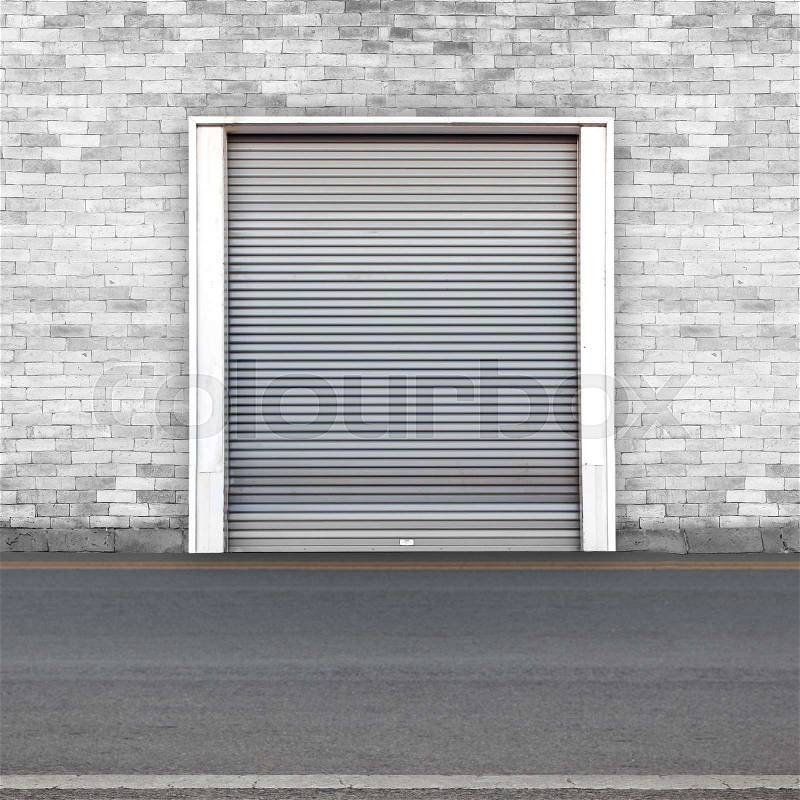 Roller shutter door and concrete floor outside factory building for industrial background, stock photo