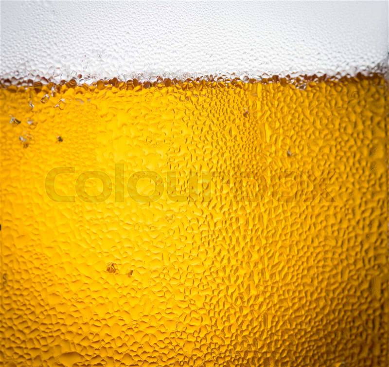 Background beer and bubbles with condensation droplets on the outside of the glass, stock photo