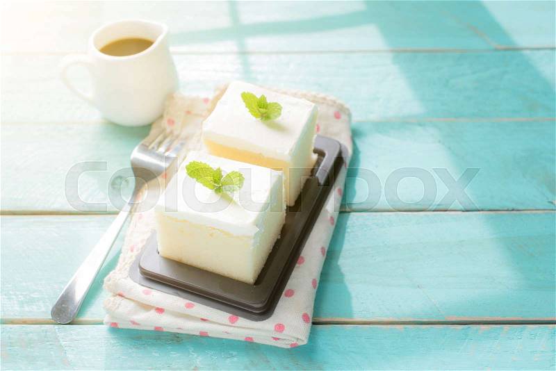 Milk cake delicious on the wood table with shadows from a window frame, stock photo