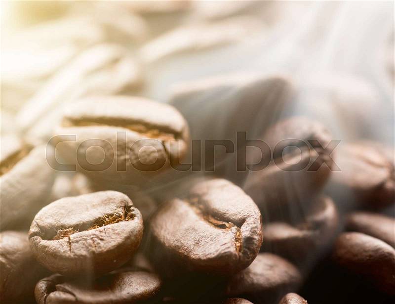 Coffee beans roasting with smoke,Selective focus, stock photo